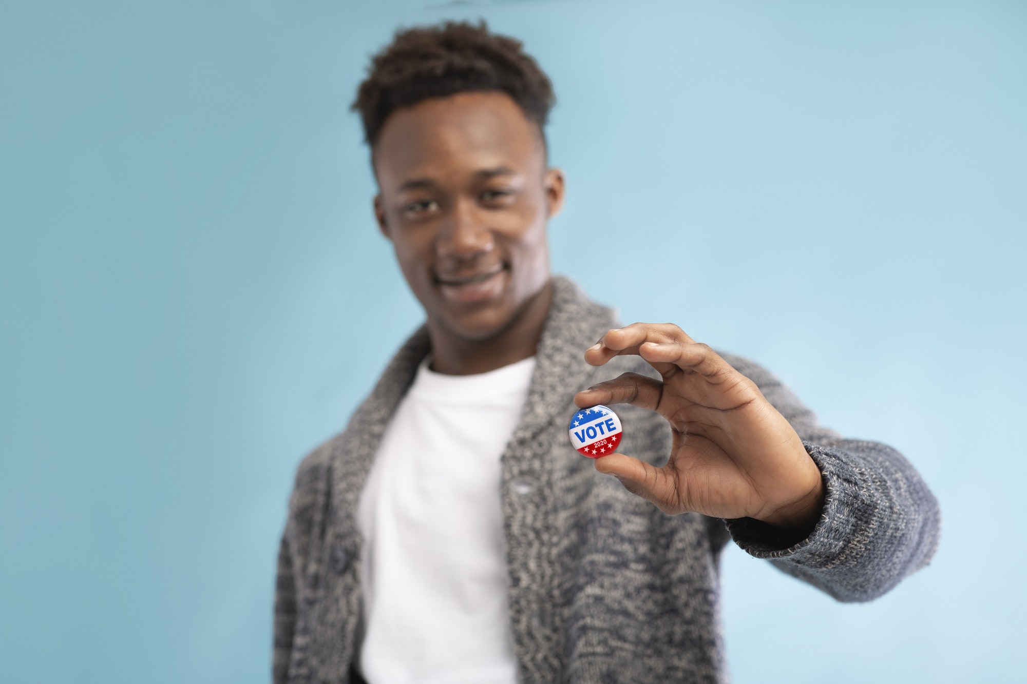 African american Man with Vote button in hand